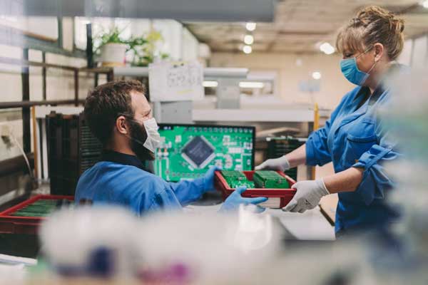 Employees working on PCB boards